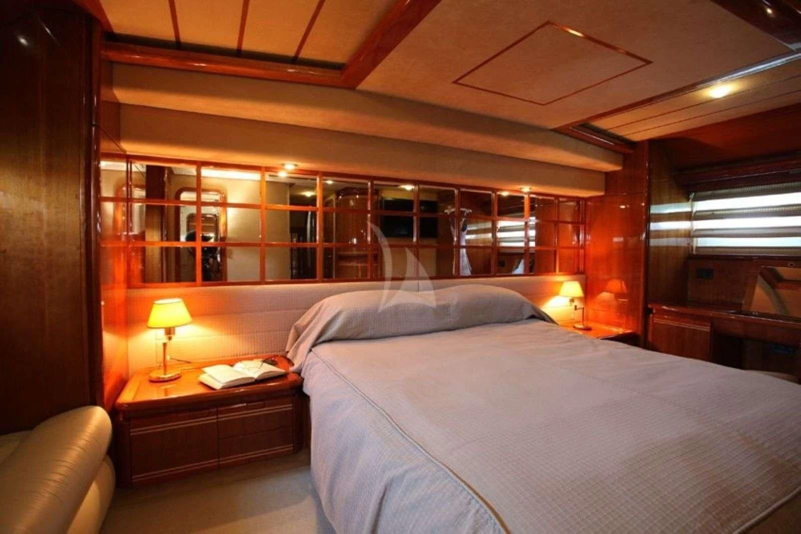 a bed with a lamp on it aboard KENTAVROS II Yacht for Charter