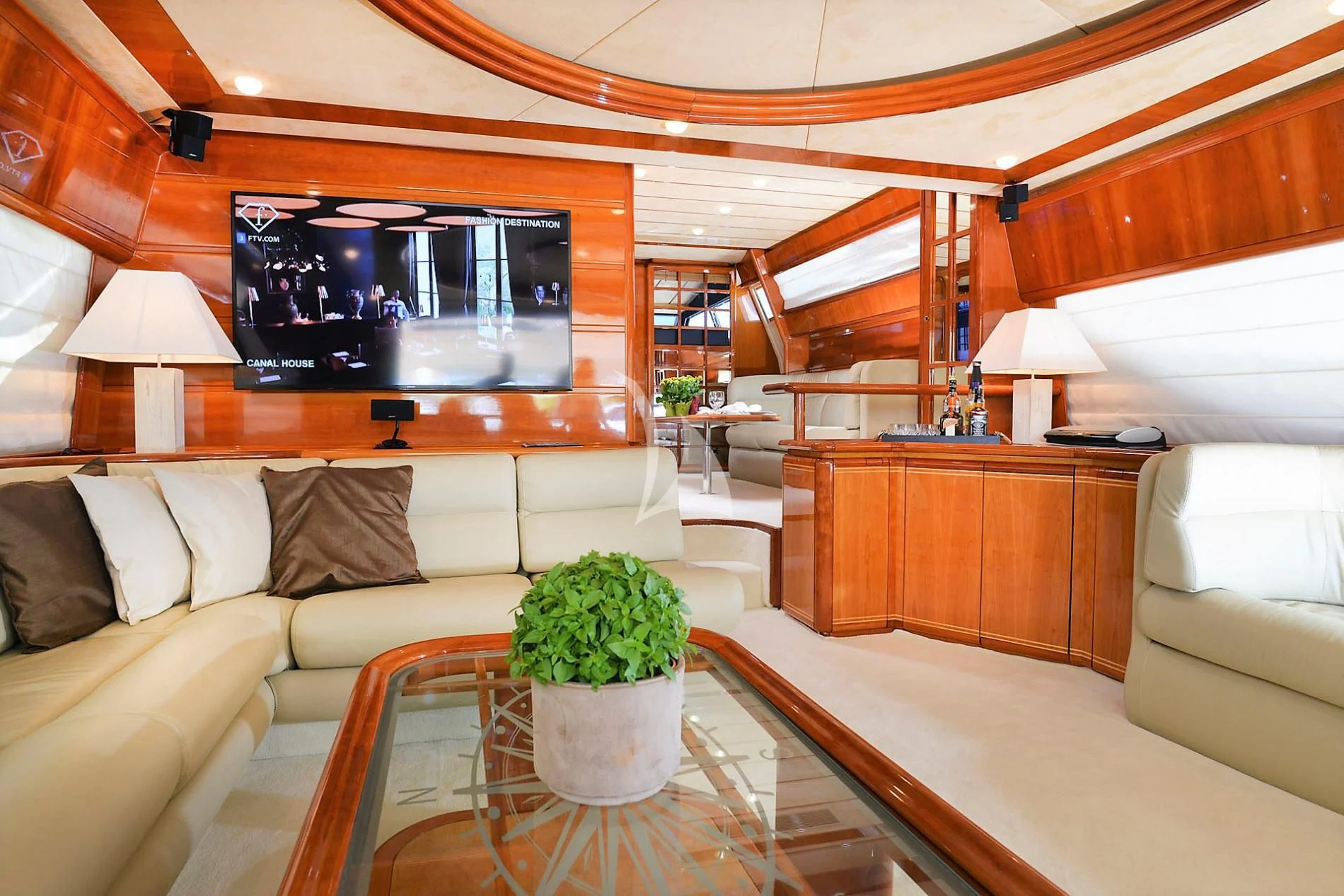 a living room with a large television aboard KENTAVROS II Yacht for Charter