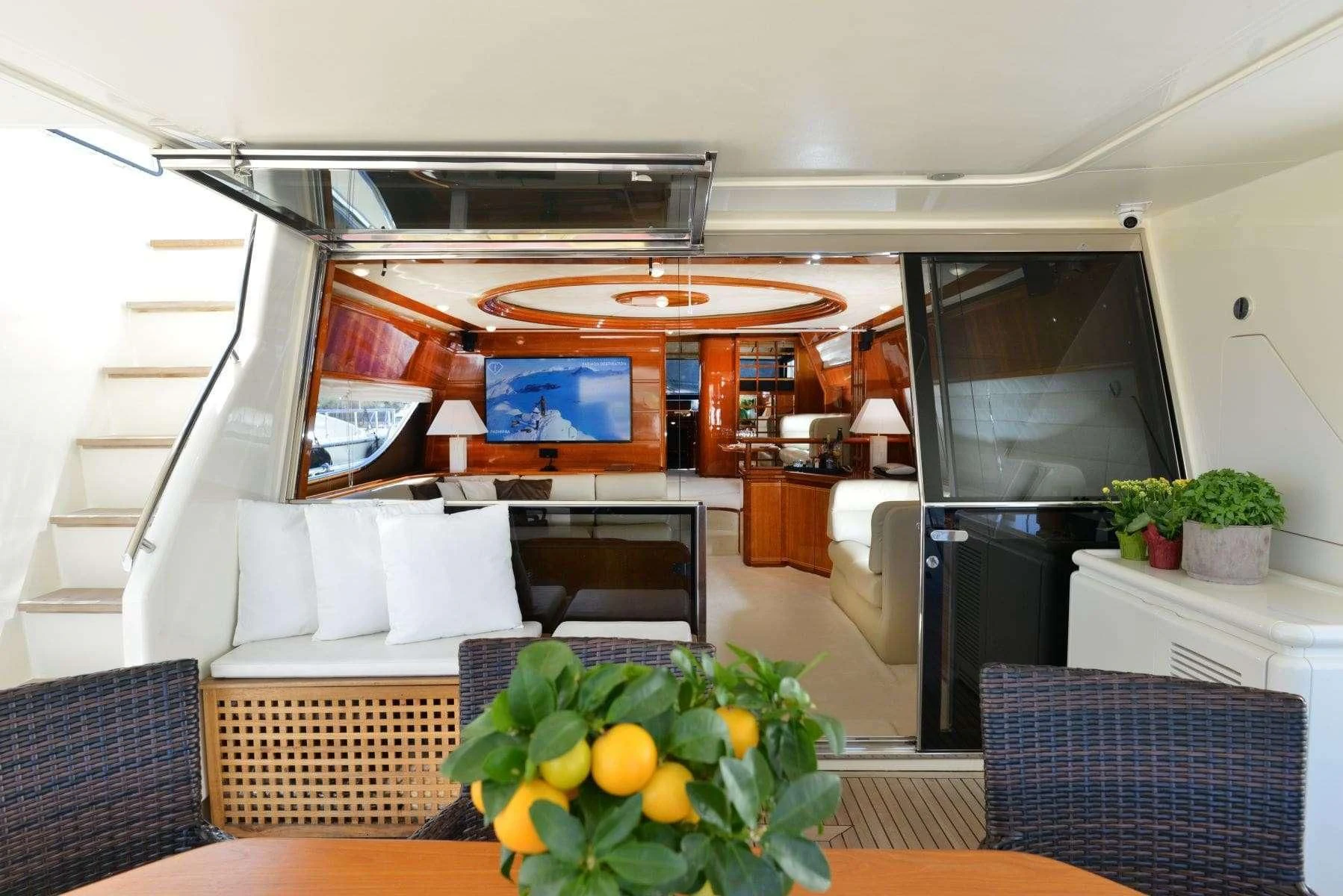 a room with a tv and furniture aboard KENTAVROS II Yacht for Charter