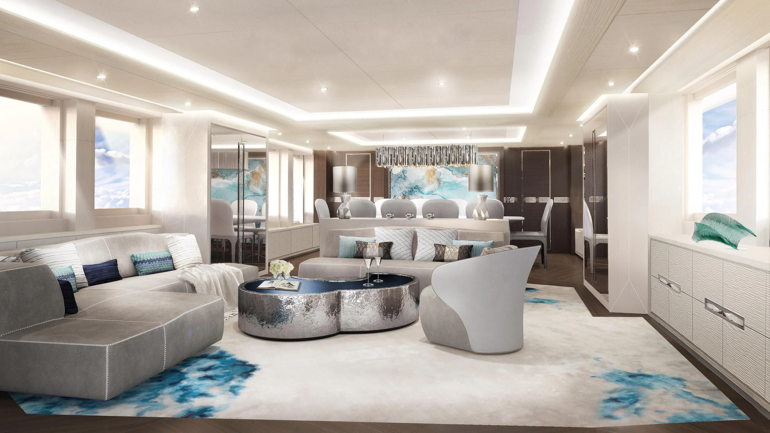 a living room with a large white couch and a large round table aboard OMAHA Yacht for Sale