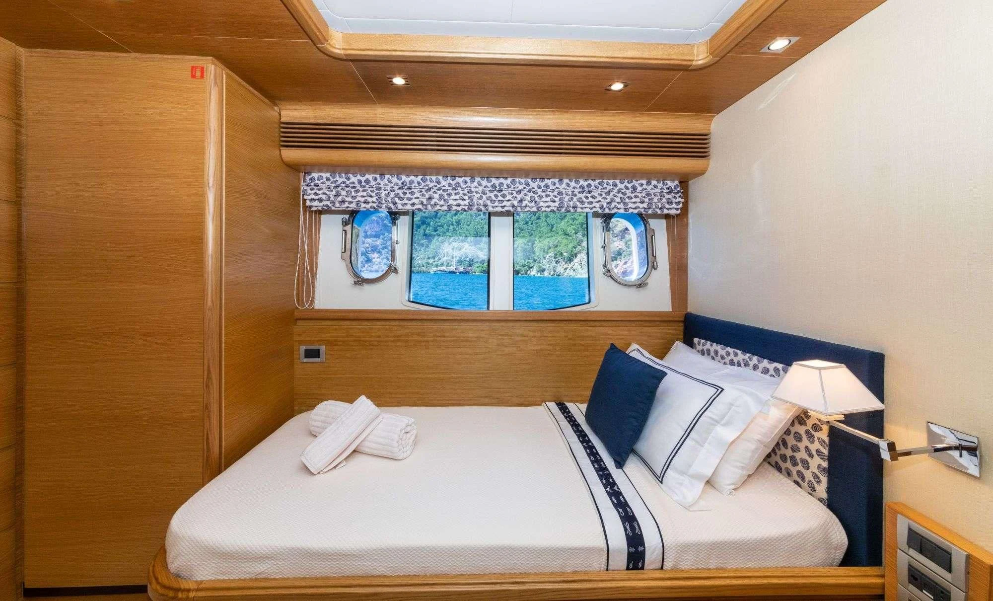 a room with a bed and a window aboard FUNDA D Yacht for Sale