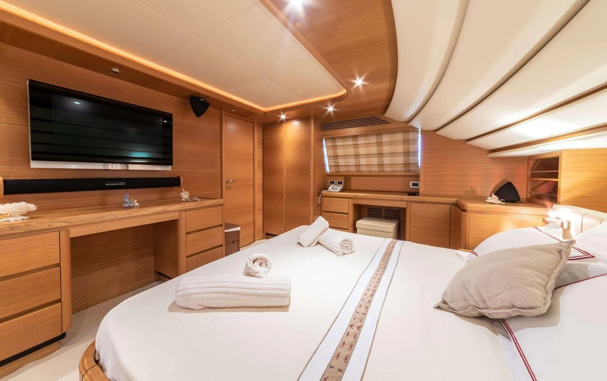 a bed with a television on the wall aboard FUNDA D Yacht for Sale