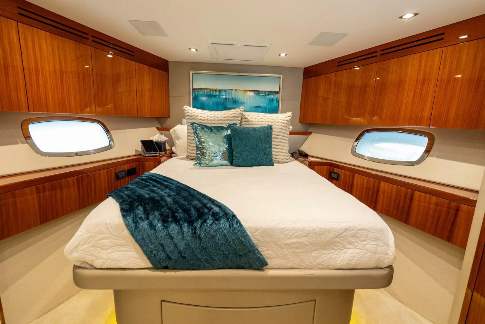 a bedroom with a large mirror above the bed aboard RITZ SEA Yacht for Sale