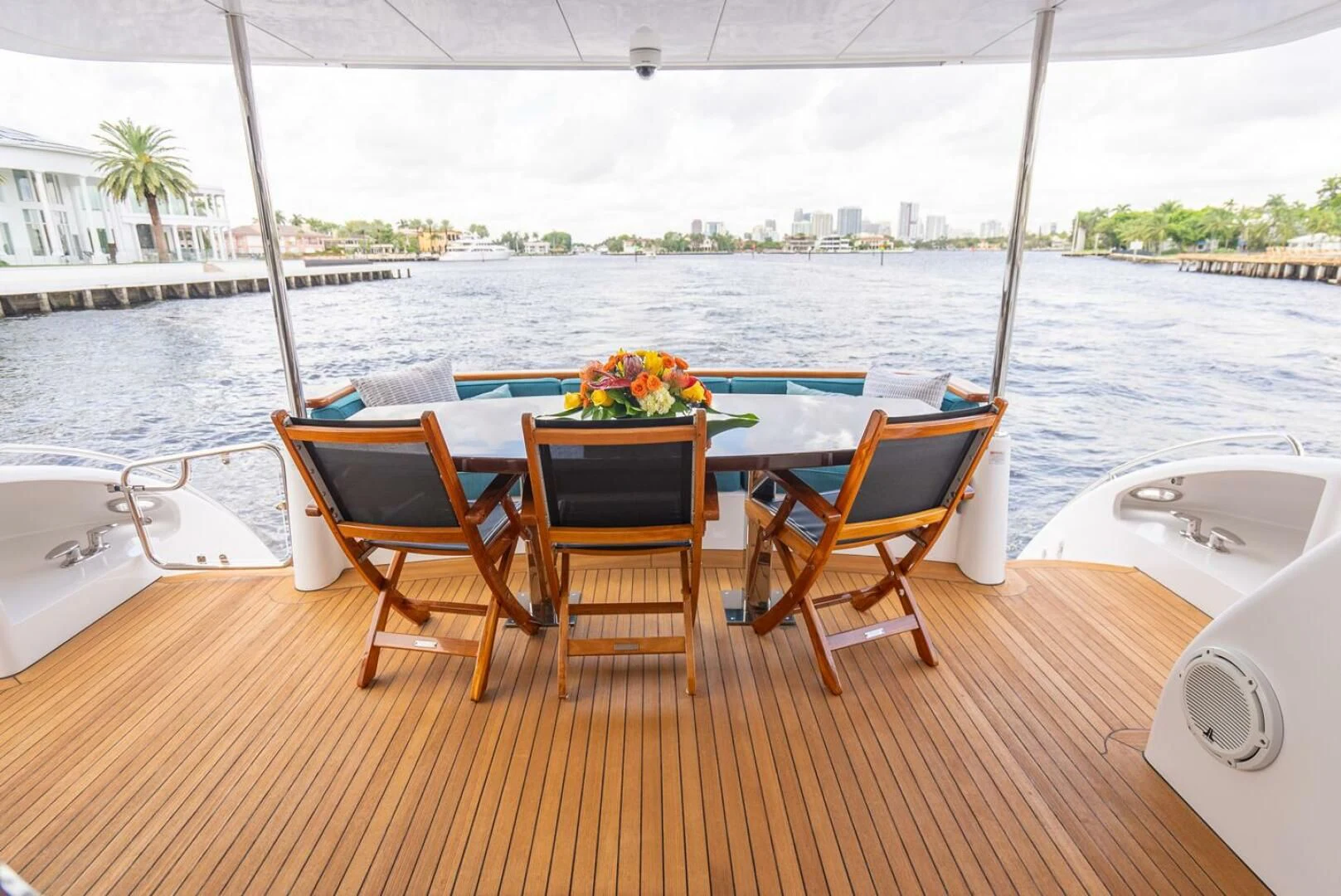 a table with chairs on a deck overlooking a body of water aboard RITZ SEA Yacht for Sale