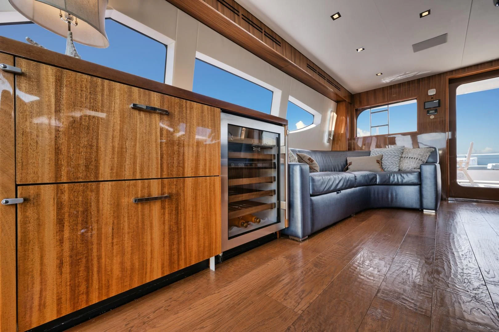 a living room with a wood cabinet aboard RITZ SEA Yacht for Sale