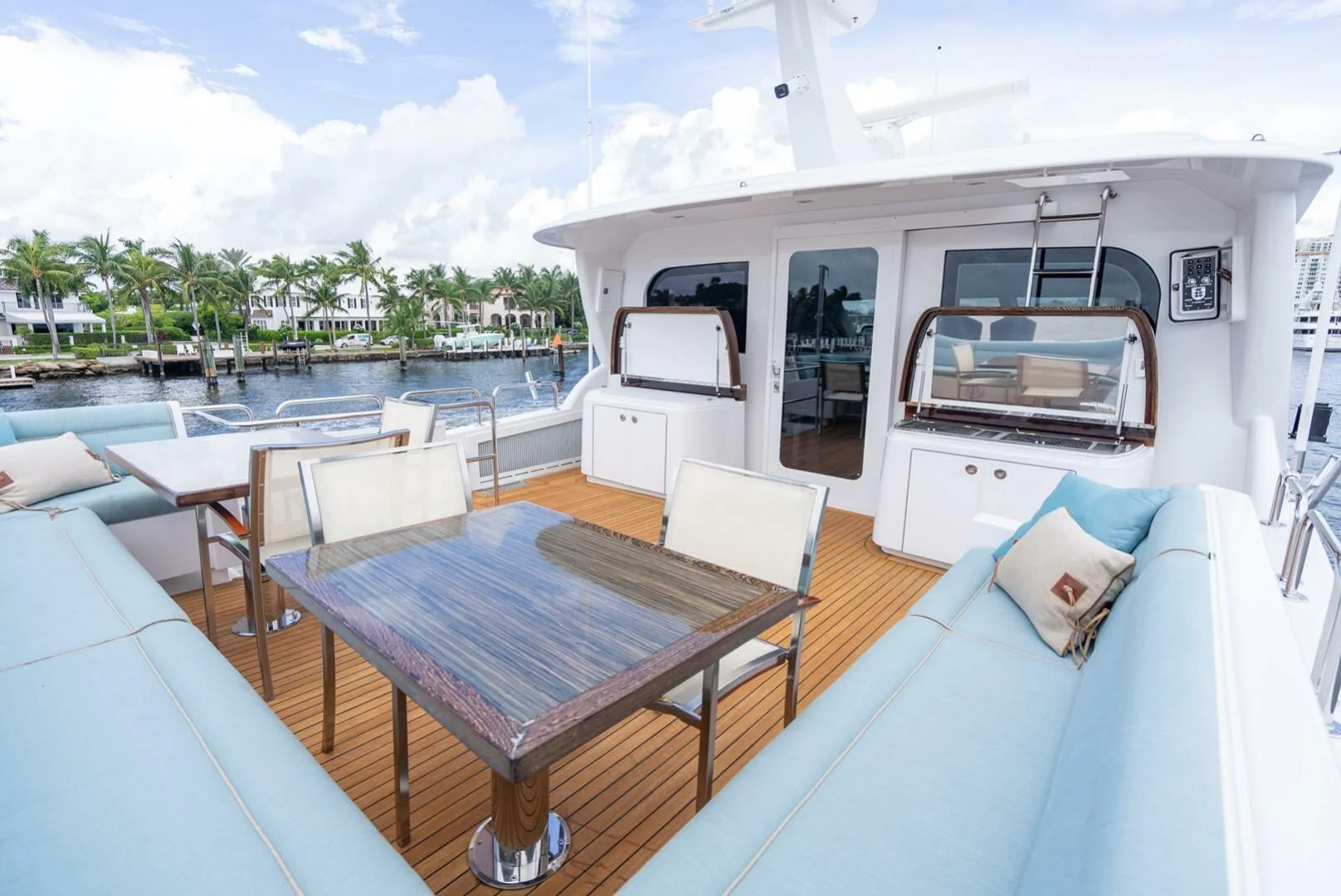 a balcony with a table and chairs aboard RITZ SEA Yacht for Sale