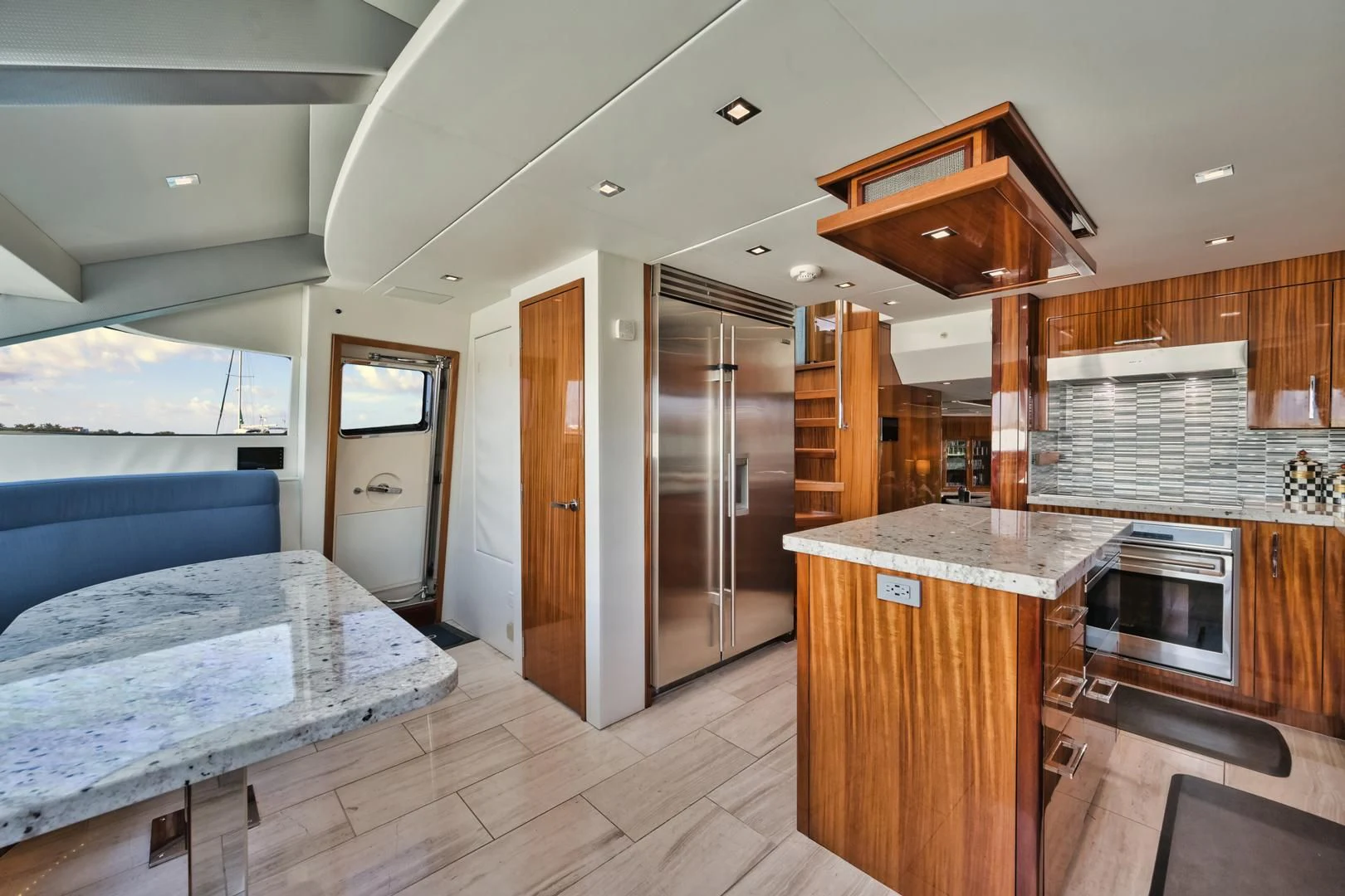 a large kitchen with wooden cabinets aboard RITZ SEA Yacht for Sale