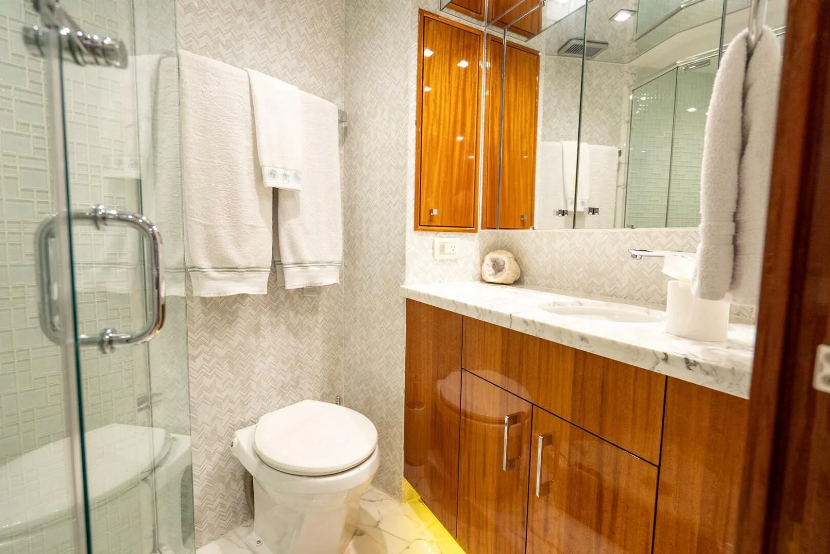a bathroom with a glass shower aboard RITZ SEA Yacht for Sale