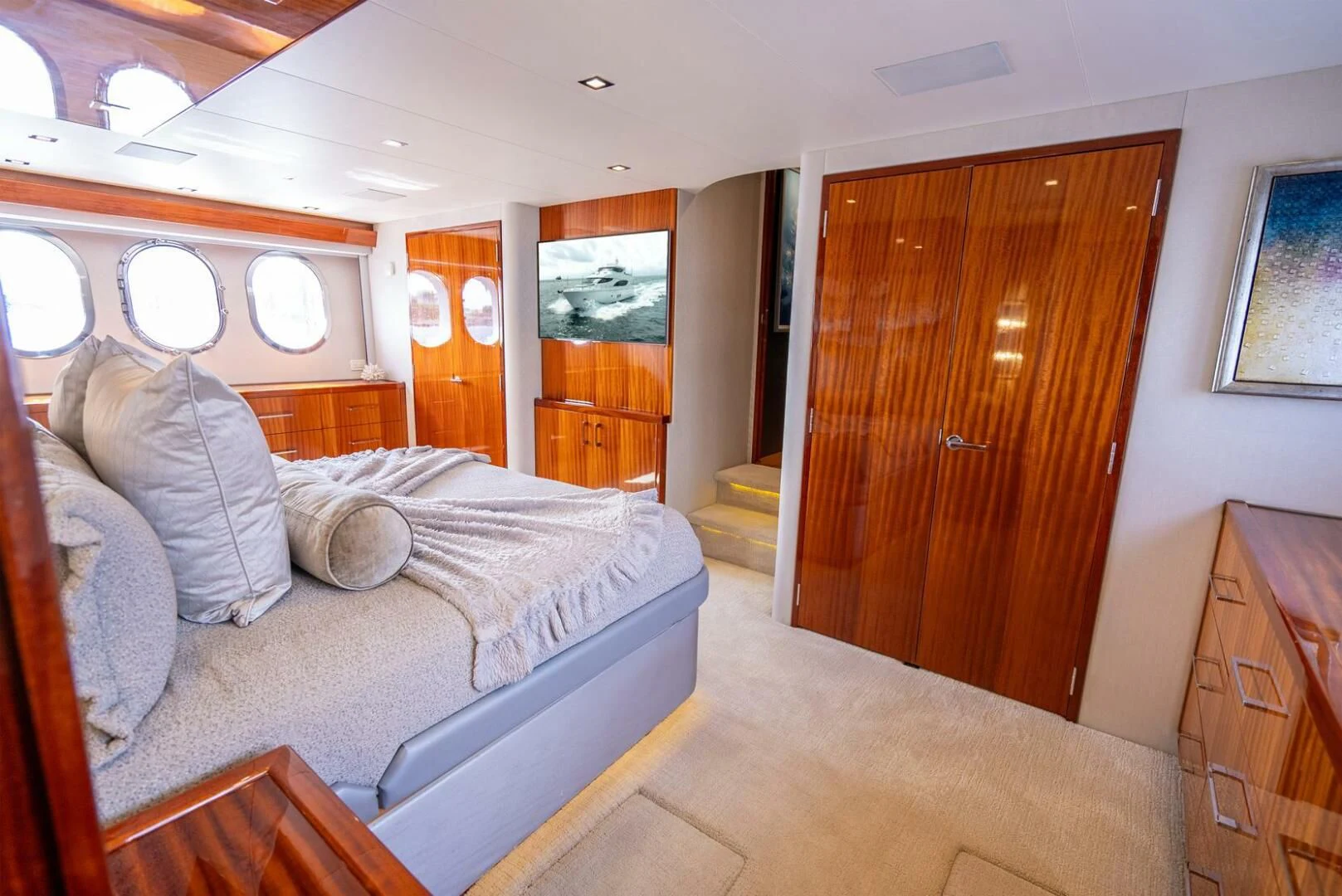 a bedroom with a bed and a wood door aboard RITZ SEA Yacht for Sale