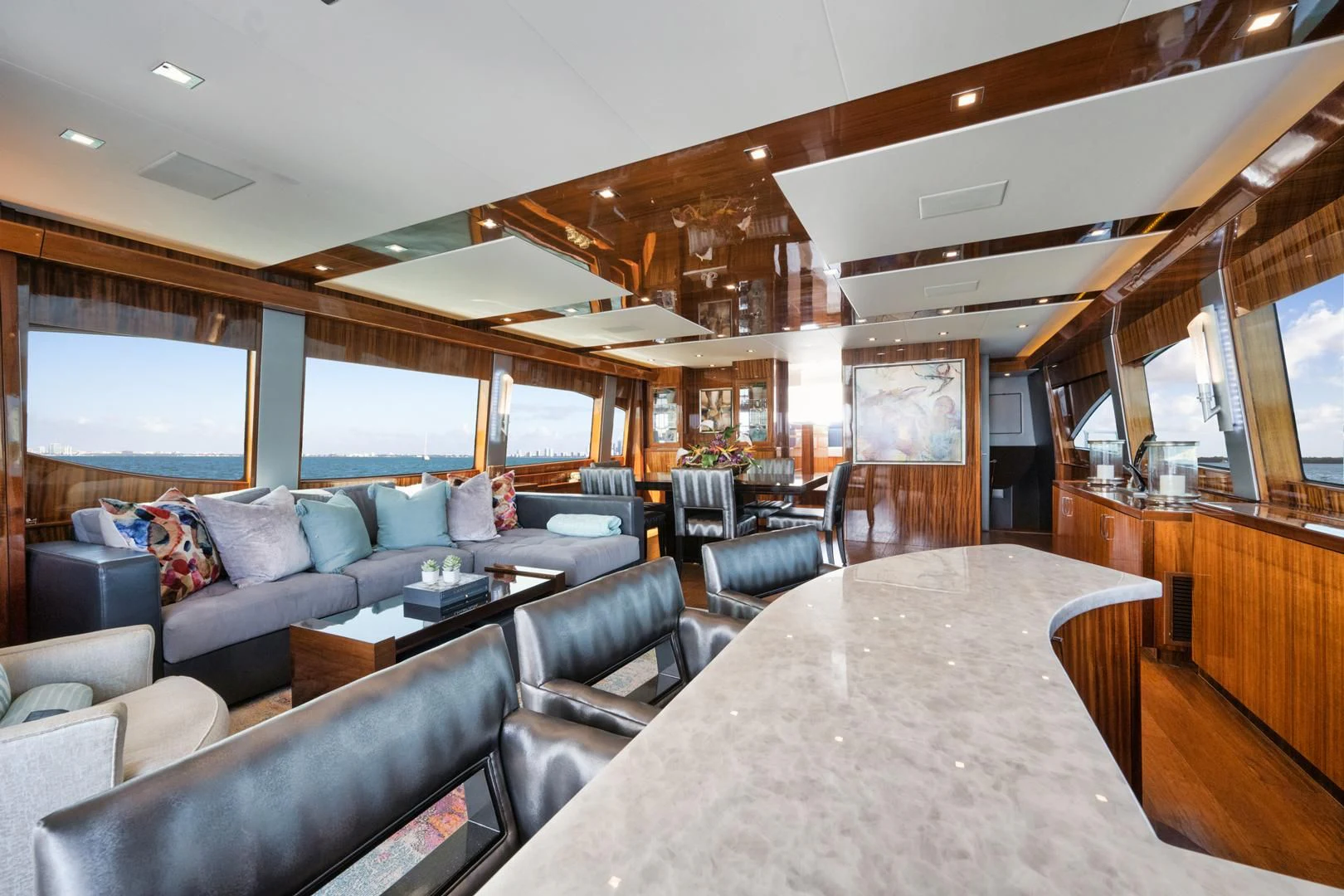 a living room with a large table and chairs aboard RITZ SEA Yacht for Sale