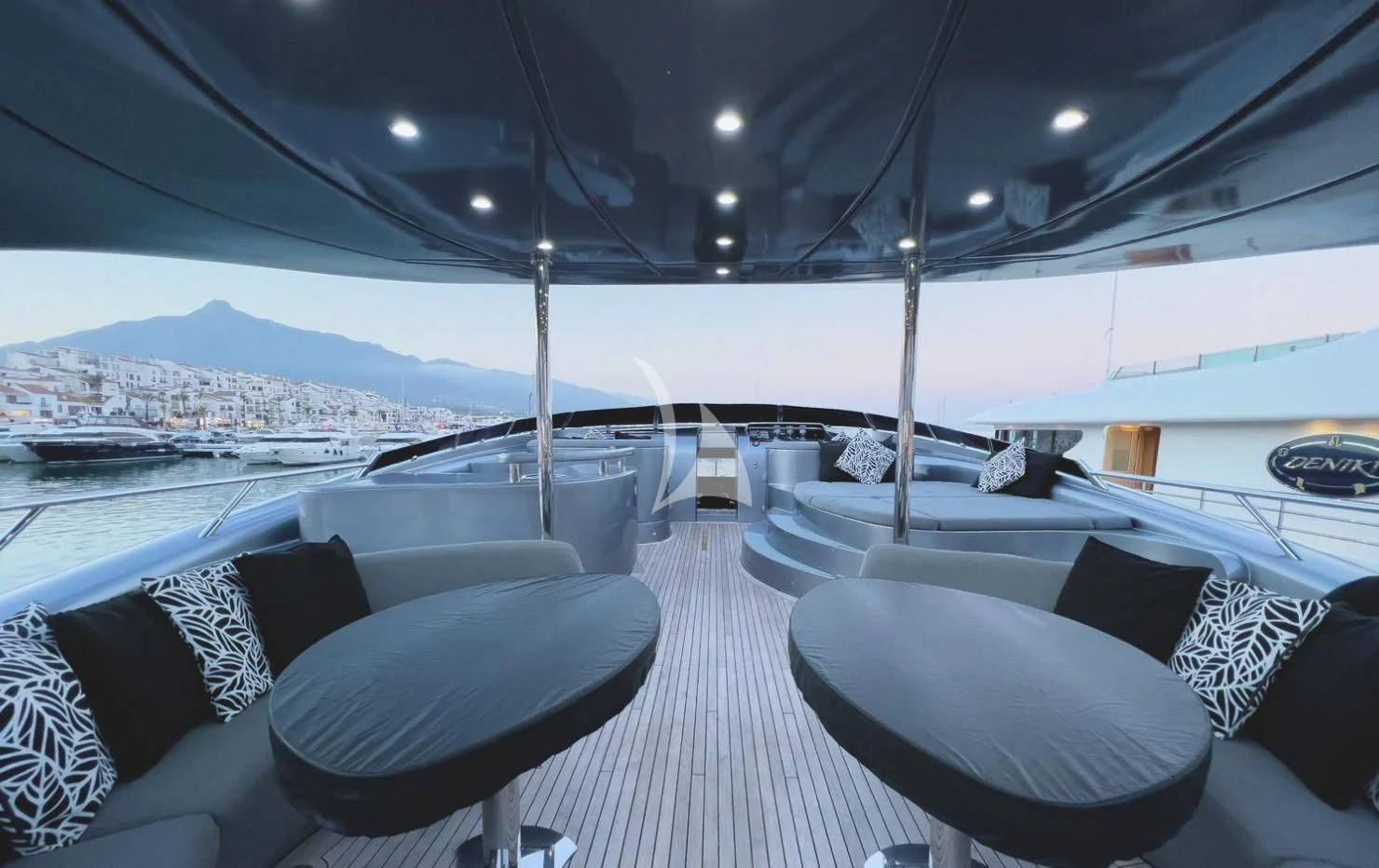 a large room with a table and chairs and a large body of water aboard MATSU Yacht for Sale