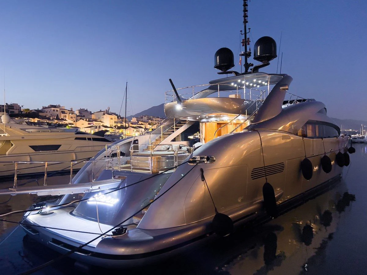 a large military ship docked aboard MATSU Yacht for Sale