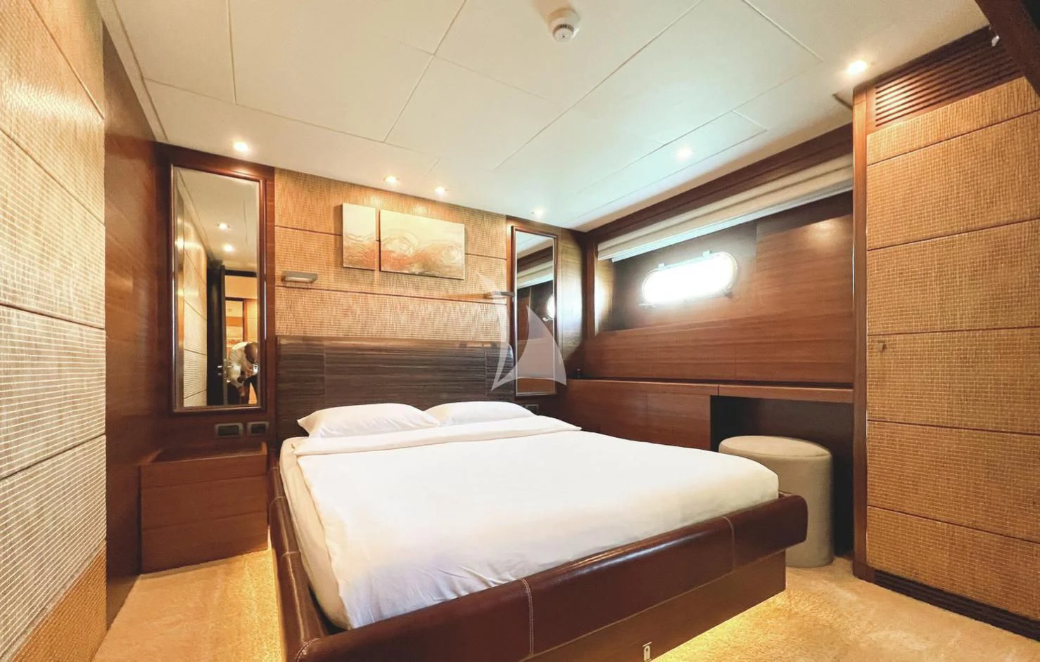 a room with a bed and a mirror aboard MATSU Yacht for Sale