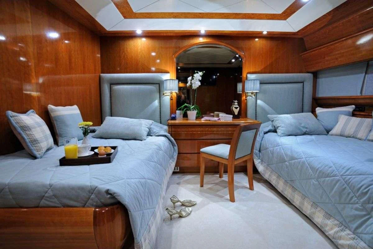 a room with a bed and a chair aboard BLU SKY Yacht for Sale