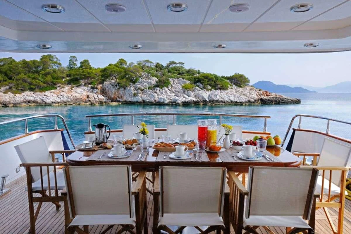 a table set for a meal on a boat aboard BLU SKY Yacht for Sale