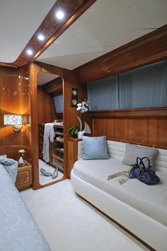 a bed with a white bed spread aboard BLU SKY Yacht for Sale