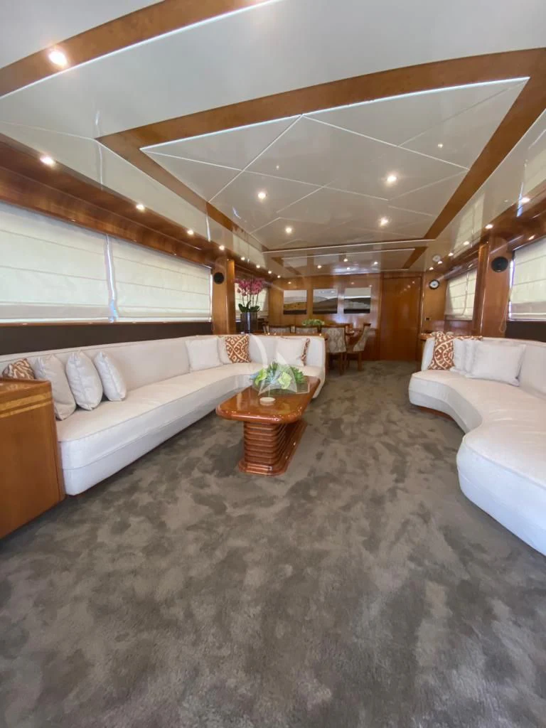 a large living room with a large bed and a table aboard BLU SKY Yacht for Sale