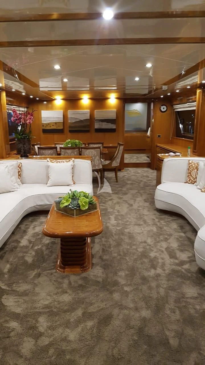 a living room with a couch and a coffee table aboard BLU SKY Yacht for Sale