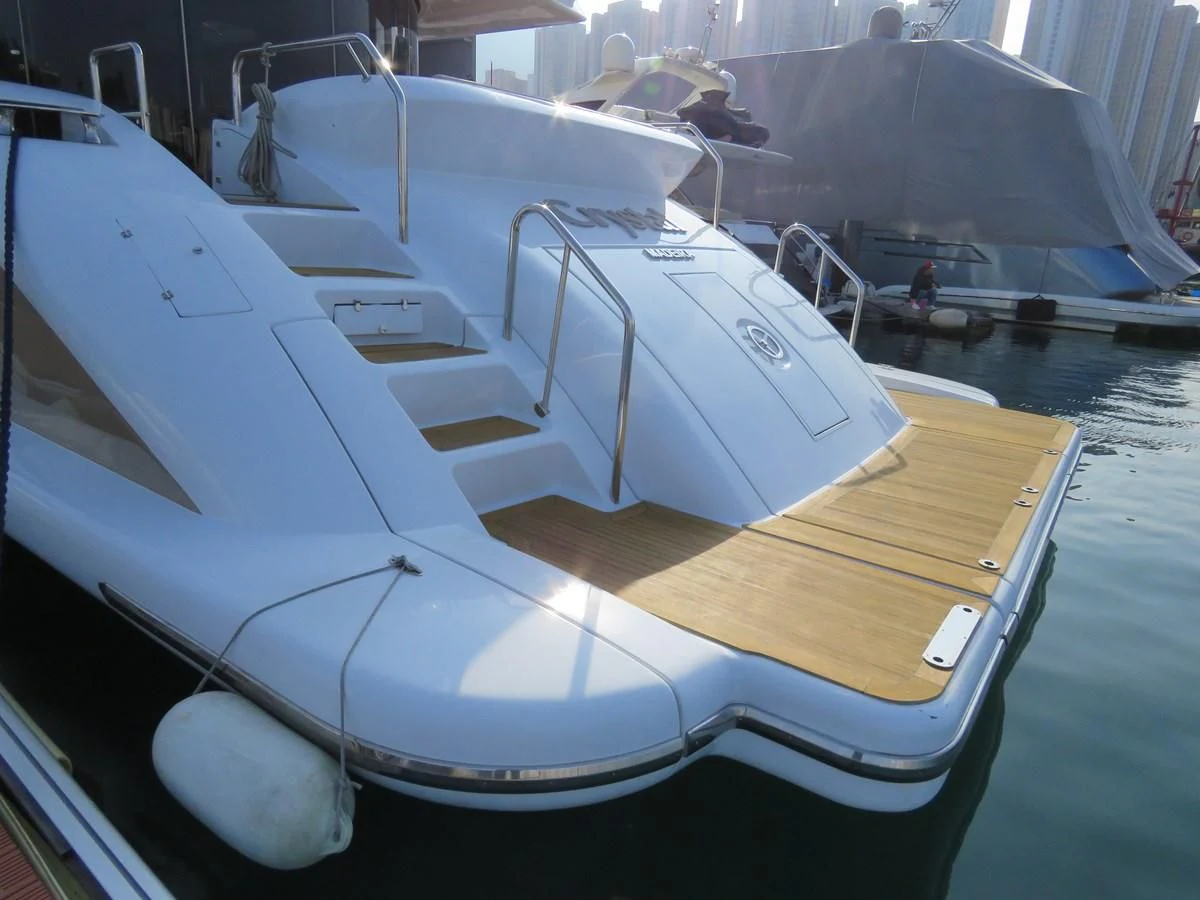 a white boat with a wooden deck aboard AERBIN Yacht for Sale