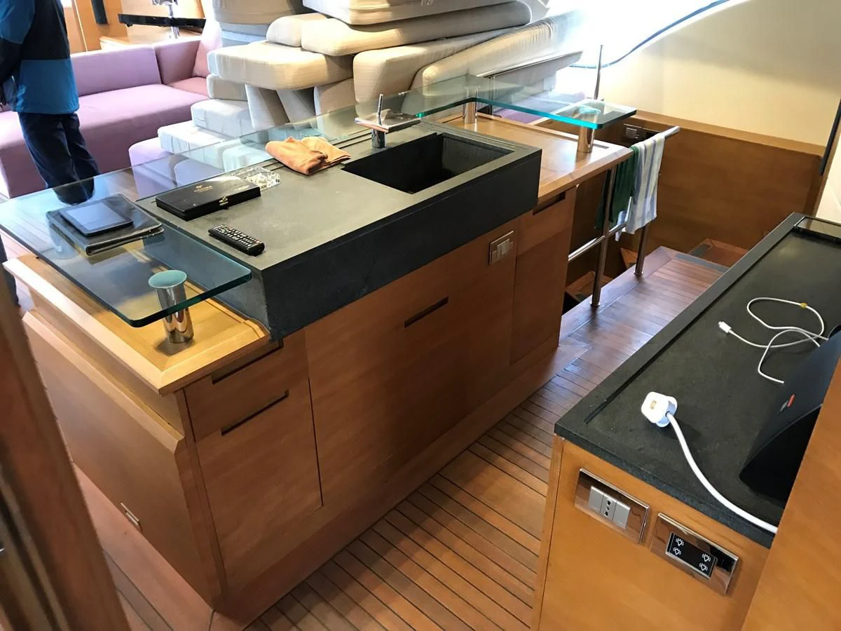 a desk with a computer and a television on it aboard AERBIN Yacht for Sale