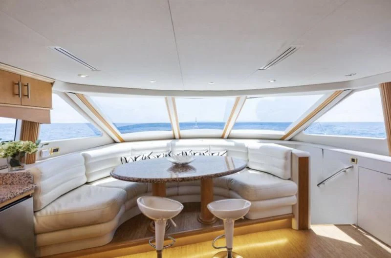 a room with a table and chairs aboard NORDLYS Yacht for Sale