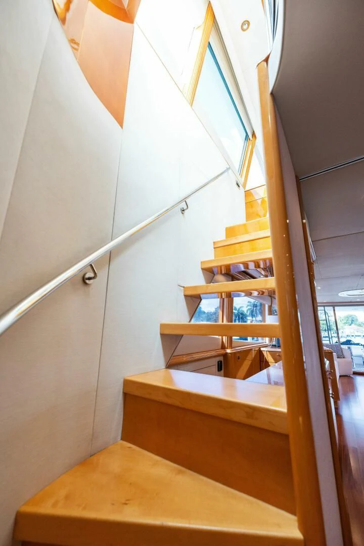 a wooden staircase with a glass window aboard NORDLYS Yacht for Sale