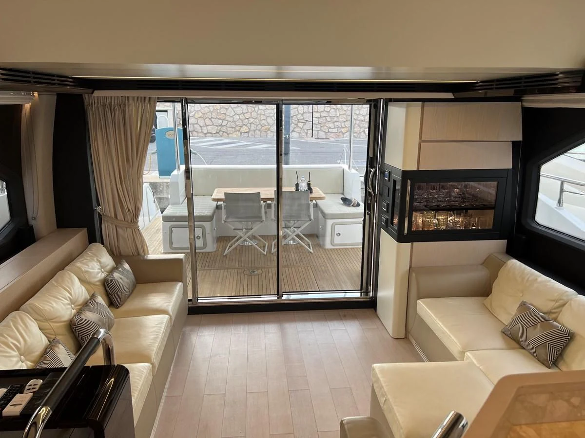 a living room with a sliding glass door aboard PAVIMAR II Yacht for Sale