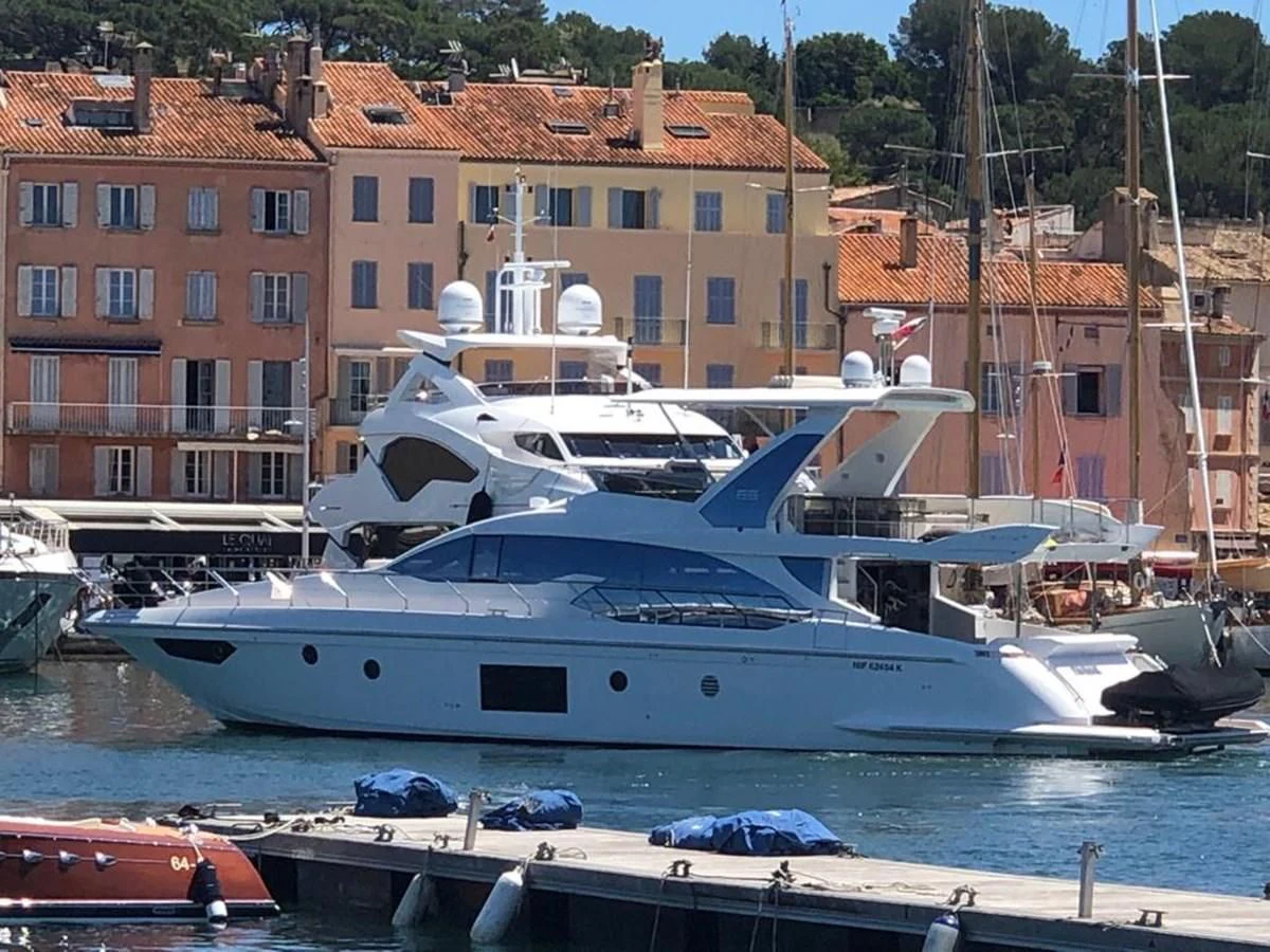 a large white boat in a harbor aboard PAVIMAR II Yacht for Sale
