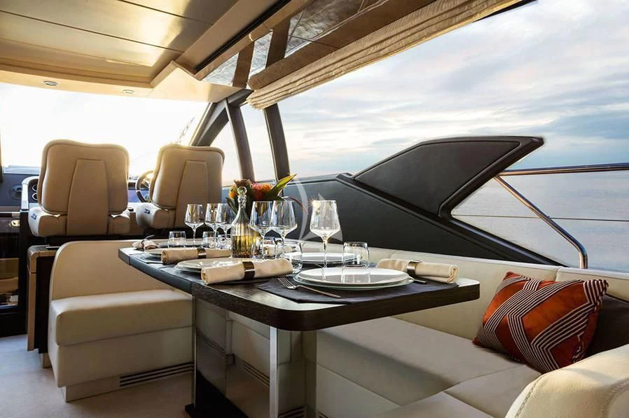 a table with chairs and a couch aboard PAVIMAR II Yacht for Sale