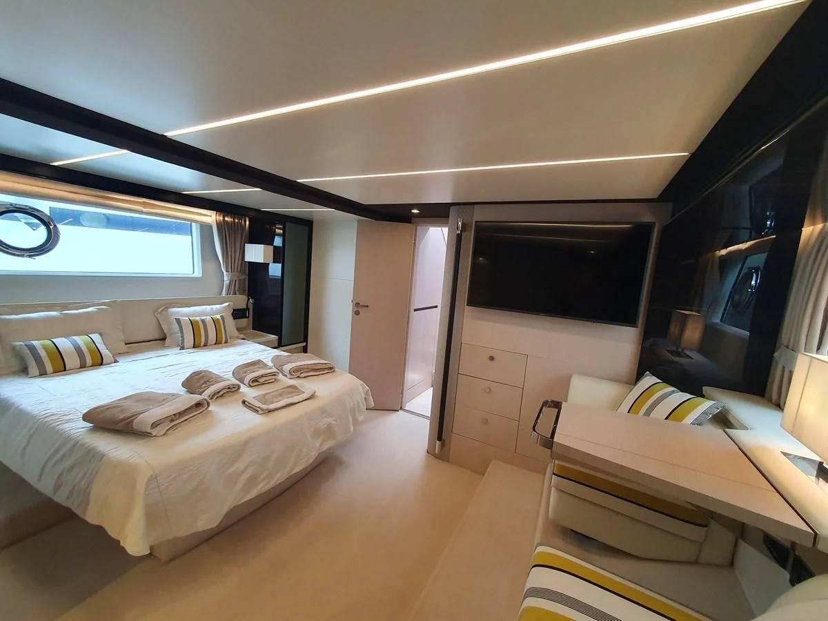 a room with a bed and a desk aboard PAVIMAR II Yacht for Sale