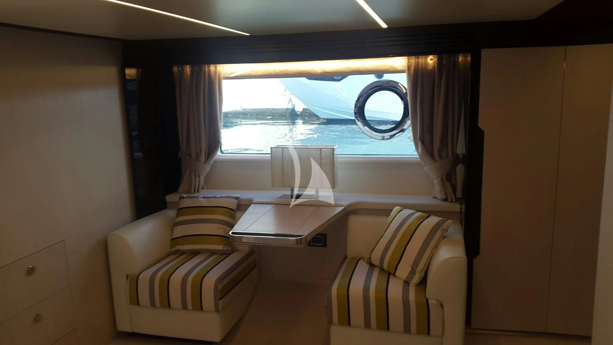 a room with a table chairs and a window aboard PAVIMAR II Yacht for Sale