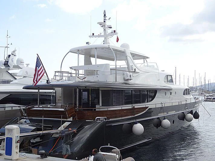 a boat with a flag on the deck aboard MAISHA Yacht for Sale