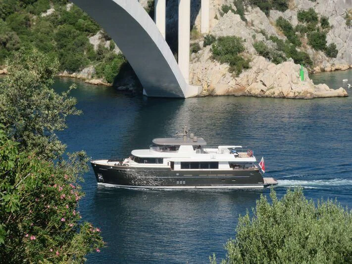 a boat sailing under a bridge aboard SEAWOLF Yacht for Sale