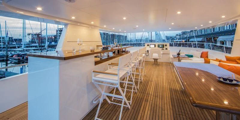 a room with a wood floor and white chairs and a wood floor aboard SEAWOLF Yacht for Sale