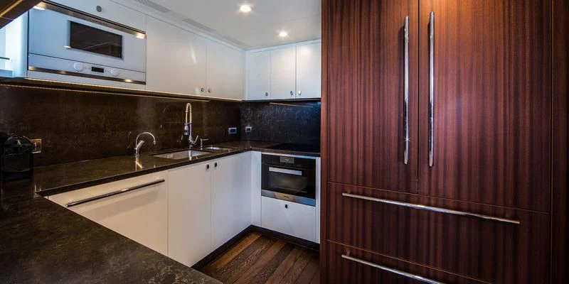 a kitchen with wooden cabinets aboard SEAWOLF Yacht for Sale