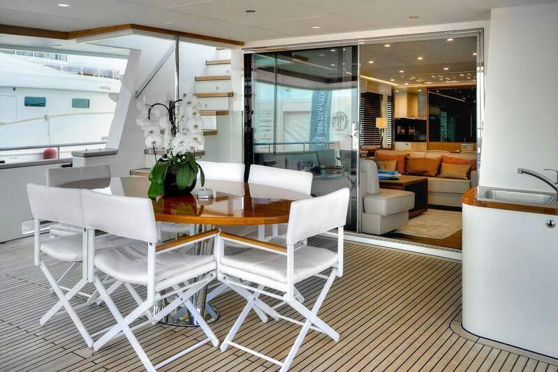 a room with a table chairs and a couch aboard SEAWOLF Yacht for Sale