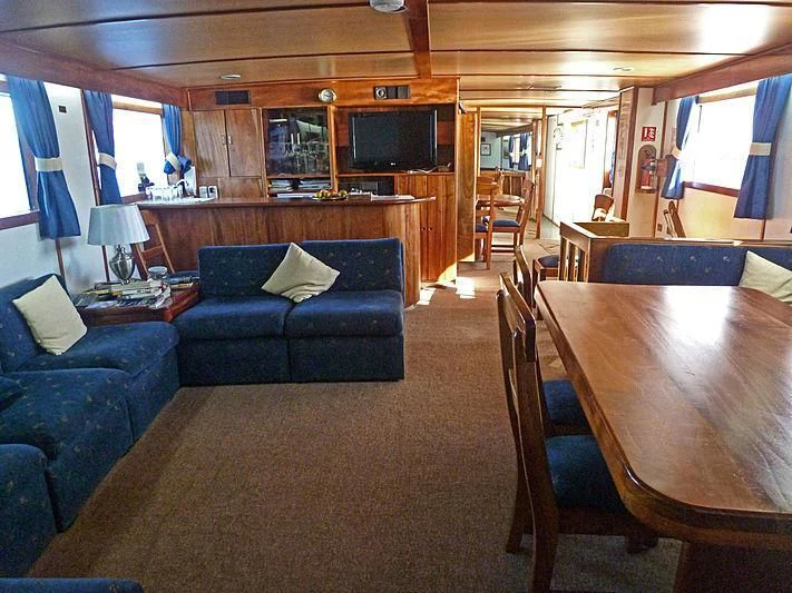 a living room with a couch and a table aboard BELUGA Yacht for Sale