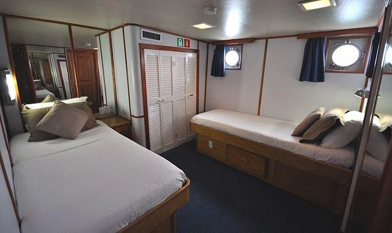 a room with a bed and a mirror aboard BELUGA Yacht for Sale