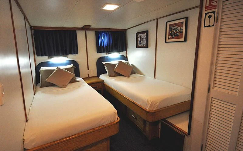 a room with two beds aboard BELUGA Yacht for Sale