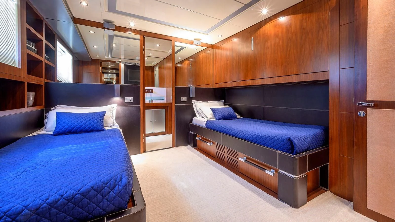 a room with a bed and a desk aboard BEYOND Yacht for Charter