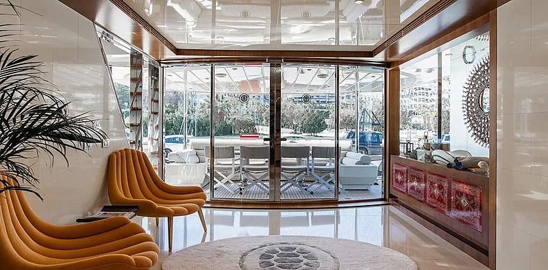 a room with a table chairs and a large window aboard BEYOND Yacht for Charter