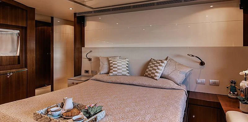 a bed with a large bed aboard BEYOND Yacht for Charter