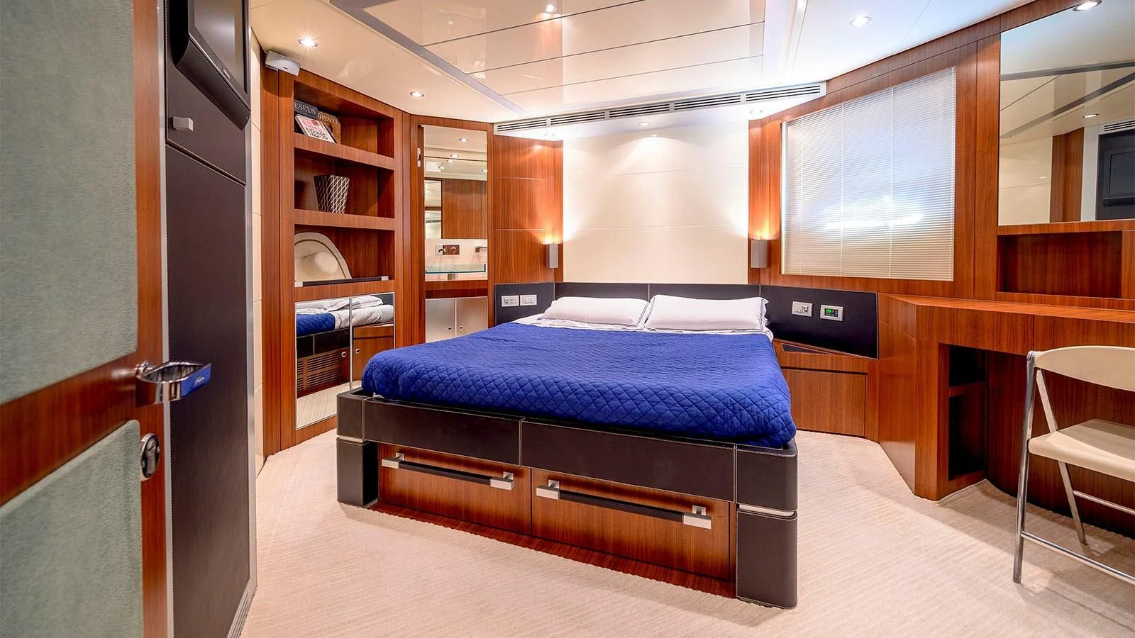 a bedroom with a bed and a desk aboard BEYOND Yacht for Charter