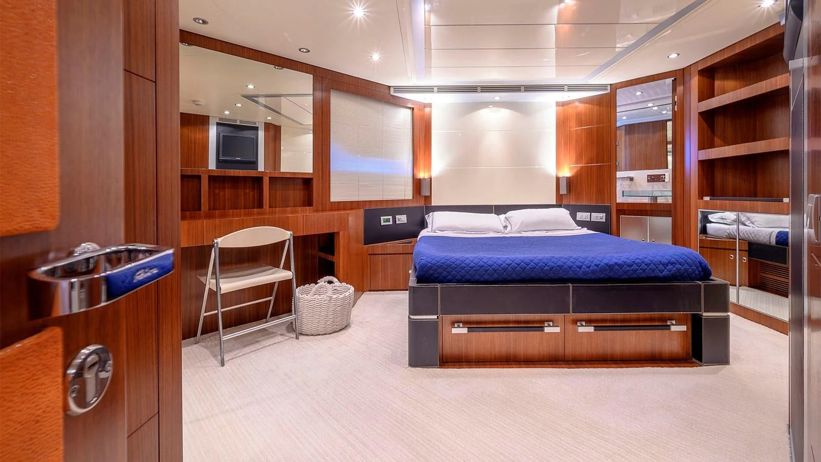a room with a bed and a chair aboard BEYOND Yacht for Charter