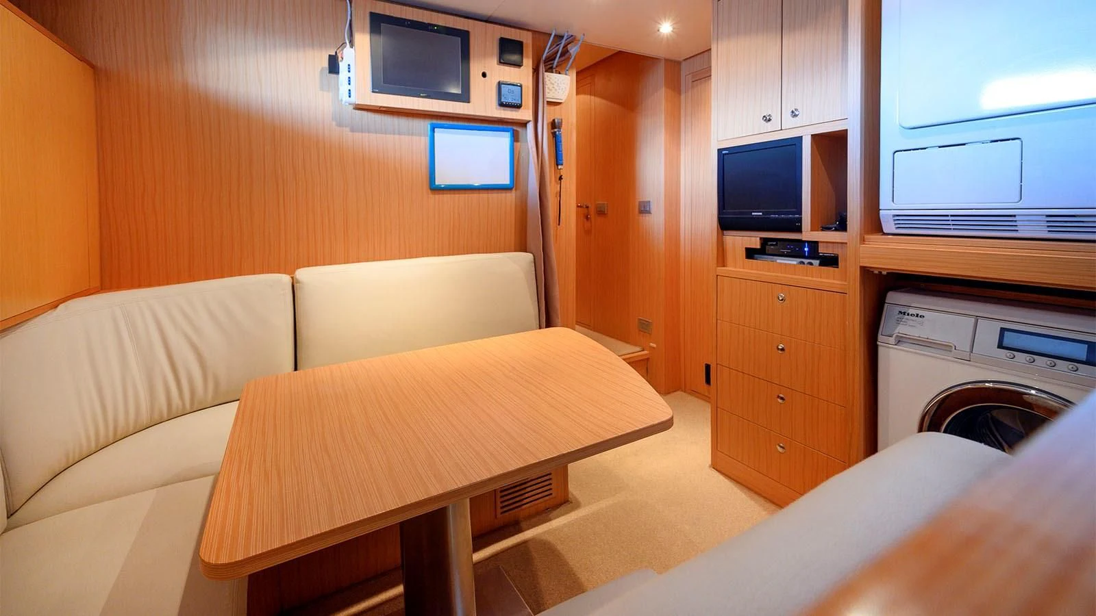 a room with a bed and a television aboard BEYOND Yacht for Charter