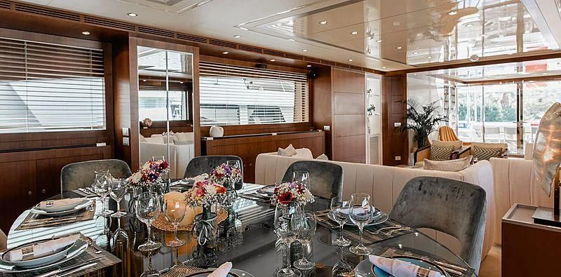 a dining room with a table and chairs aboard BEYOND Yacht for Charter