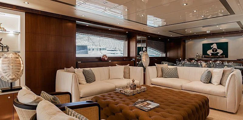 a living room with a couch and a table aboard BEYOND Yacht for Charter