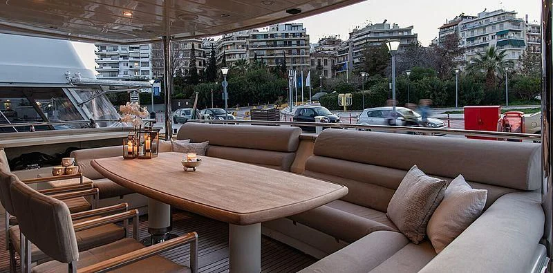 a room with a table and couches aboard BEYOND Yacht for Charter