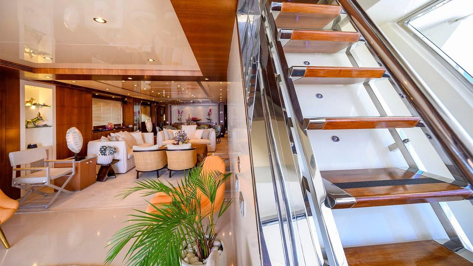 a room with a staircase and chairs aboard BEYOND Yacht for Charter