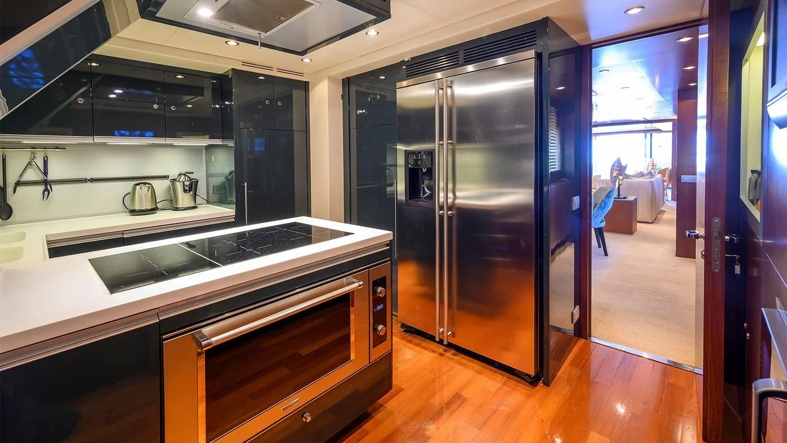 a kitchen with a large stainless steel refrigerator aboard BEYOND Yacht for Charter
